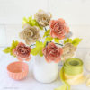 frosted paper ranunculus flowers in white vase