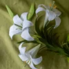 Easter lily crepe paper flower bundle sits on green cloth