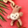 Cute face details of felt climbing monkeys