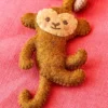 Closeup of DIY felt climbing monkey