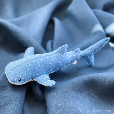 blue felt whale shark on a blue fabric background