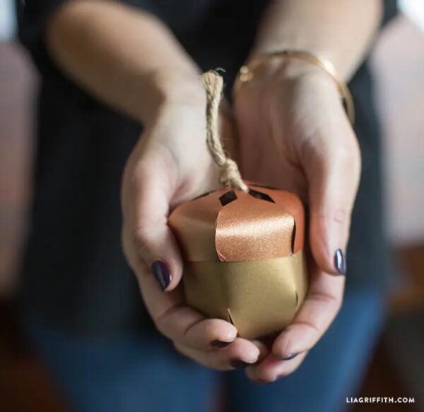 diy metallic paper acorns in hand