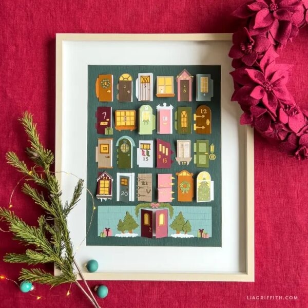 layered cardstock advent calendar top down view on red cloth background