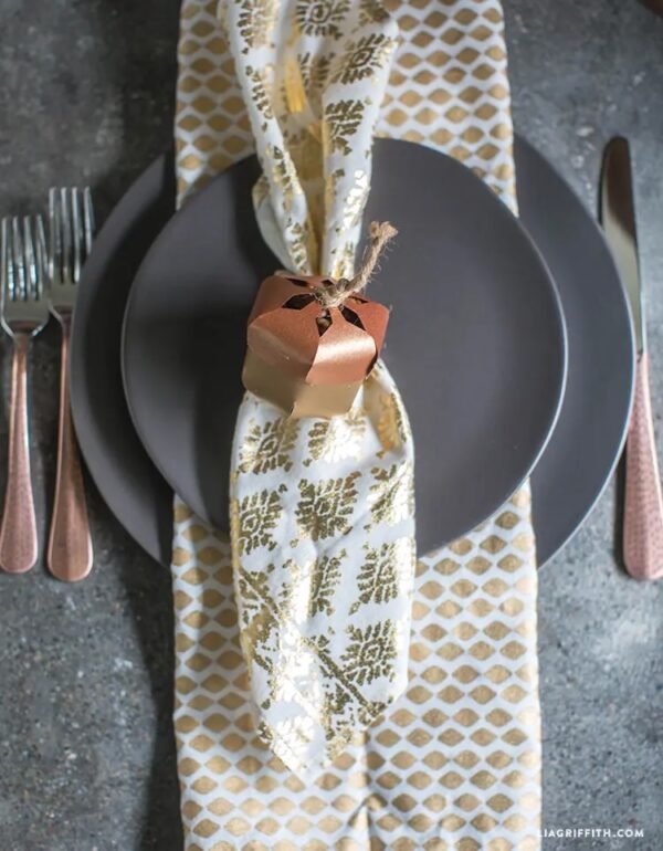 diy metallic paper acorns as napkin ring