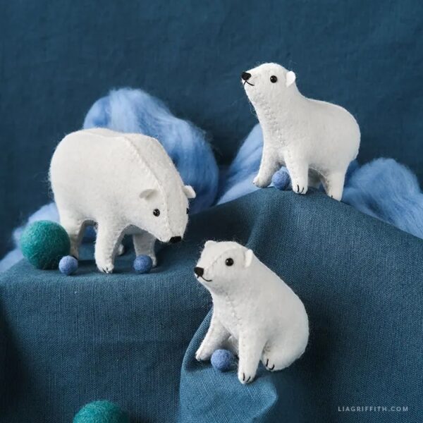 felt polar bear cubs on top of a mountain