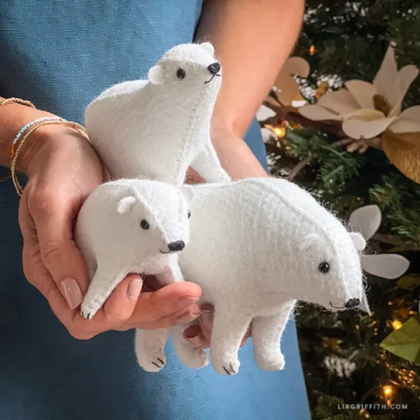 felt polar bear cubs held in hands