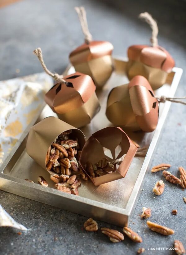 diy metallic paper acorns holding pecans