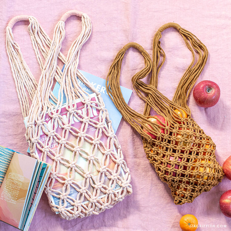 One white macrame bag with books and one brown macrame bag with apples.