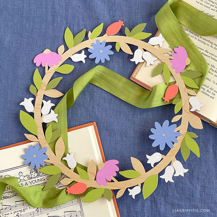 A painted wooden wreath on some music books.